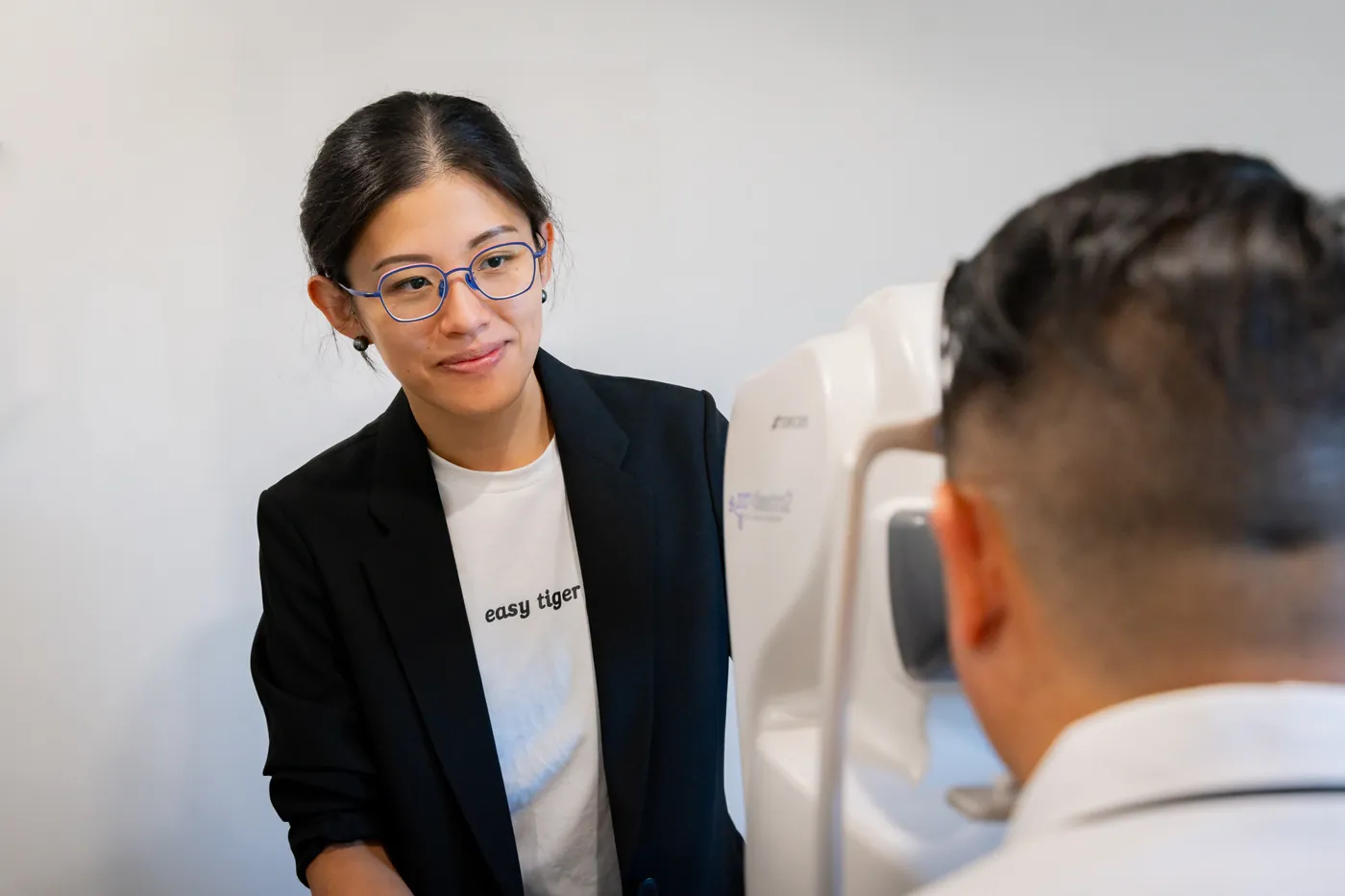 An optometrist beside the retinal camera at E Eye Place Shelley
