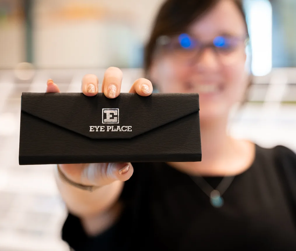 An E Eye Place team member holding up a branded glasses case, Perth