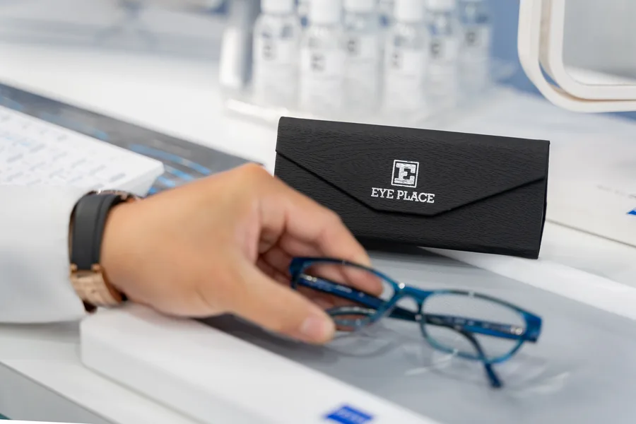 A pair of glasses and an E Eye Place case on the dispensing desk in Shelley