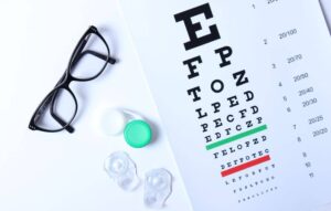 Contact lenses, eyeglasses and eye chart.