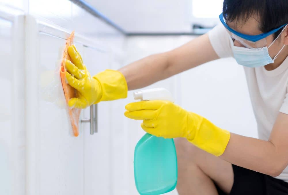 Cleaning man wearing eye protection.