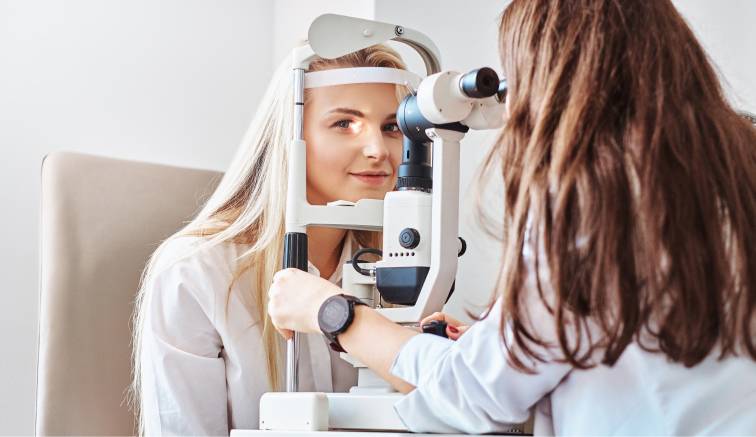 An individual receiving a dry eye diagnosis test, with an eye care professional using diagnostic equipment to assess their eye health