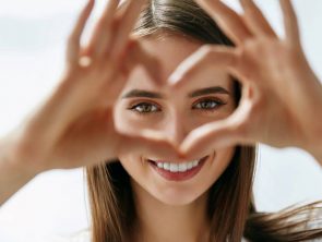 Happy woman showing beautiful eyes.