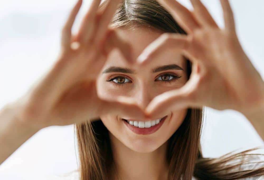 Happy woman showing beautiful eyes.