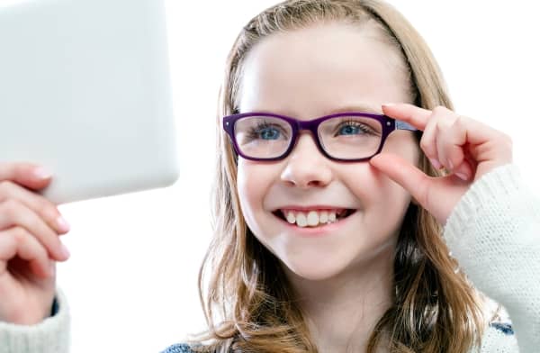 Girl trying on new glasses.