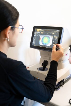 Optometrist performing an eye test looking for myopia in the patients eye.